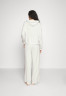 Tommy Hilfiger LONG PANTS TAPE EXT SIZES Tracksuit bottoms ecru LONG PANTS TAPE EXT SIZES Спортивные штаны экрю