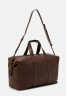 Tommy Hilfiger PREMIUM LEATHER DUFFLE UNISEX Weekend bag dark chestnut КОЖАНАЯ СУМКА PREMIUM UNISEX Сумка выходного дня темно-каштановый