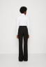 Tommy Hilfiger SEASONAL FLARE PANT Trousers black БРЮКИ SEASONAL FLARE PANT Брюки черный
