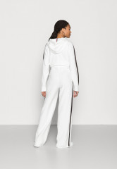 Tommy Hilfiger FLEX WIDE LEG PANT Tracksuit bottoms ecru FLEX WIDE LEG PANT Брюки от спортивного костюма экрю