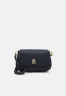 Tommy Hilfiger EMBLEM FLAP CROSSOVER Across body bag space blue EMBLEM FLAP CROSSOVER Сумка через плечо космический синий