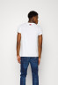 Tommy Hilfiger TOMMY HILFIGER X SHAWN MENDES THE SHAWN TEE UNISEX Basic T-shirt white TOMMY HILFIGER X SHAWN MENDES THE SHAWN TEE UNISEX Базовая футболка белый